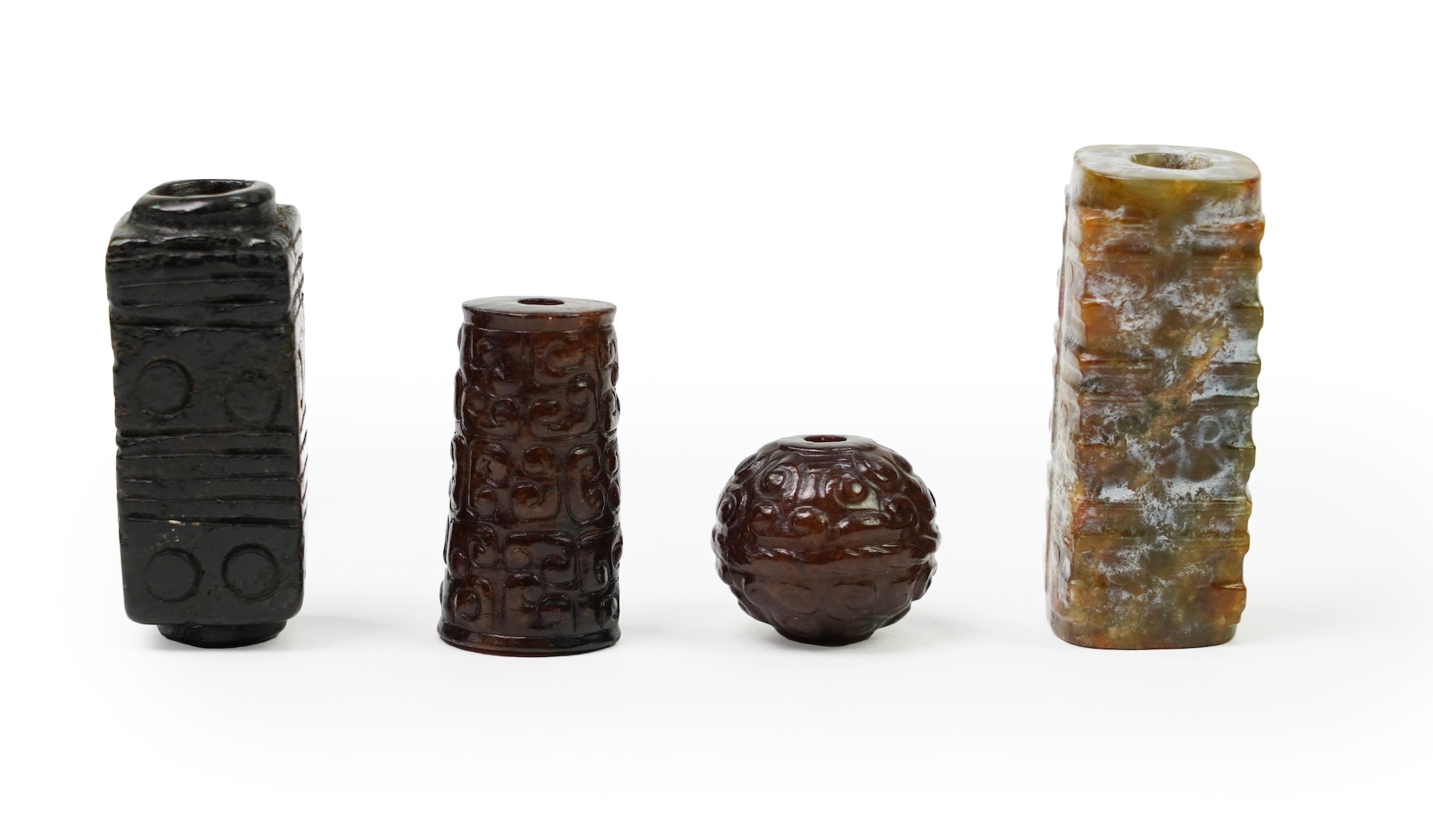 A group of four Chinese archaistic jade beads